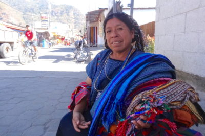 Maya-woman-selling-textiles-in-Guatemala